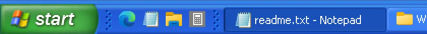 The same taskbar unlocked: dotted grips on both sides of Quick Launch.